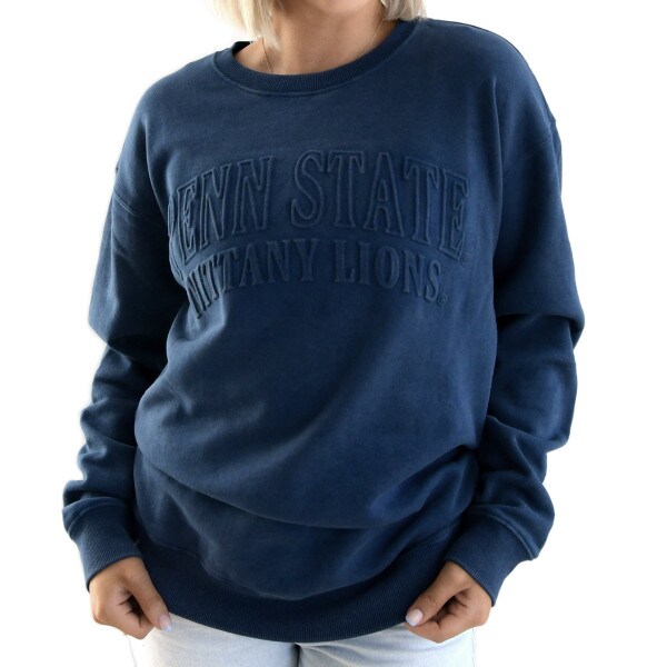 model wearing navy long sleeve crew neck sweatshirt with embossed Penn State Nittany Lions